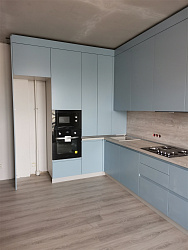 Угловая кухня голубого цвета с высокими верхними шкафами и пеналом